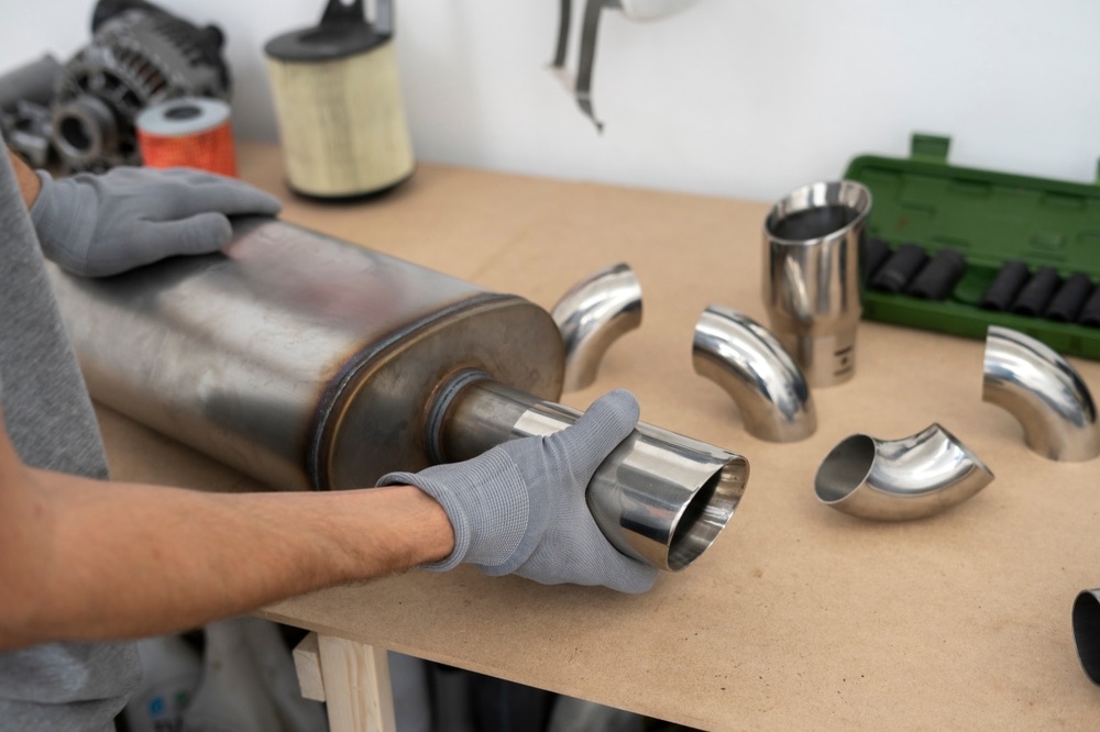 DPF and exhaust system on workbench – Auto Parts Wholesale Berlin